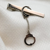 Vintage Gold‑Tone Tie Clip w/ Dangling Handcuff Charm – 2"