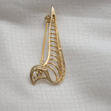 Vintage Gold‑Tone Openwork Brooch – Curved Filigree Design with Accent Stones