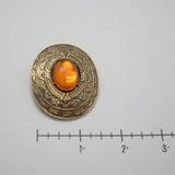 Vintage Gold‑Tone Ornate Brooch – Engraved Border & Amber Cabochon Center