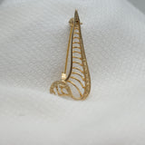 Vintage Gold‑Tone Openwork Brooch – Curved Filigree Design with Accent Stones